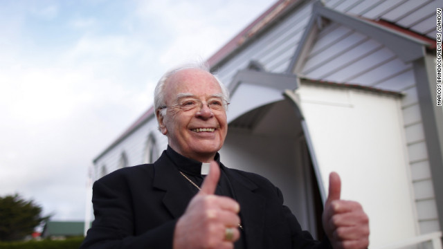 Catholic Monsignor Michael McPartland gestures his approval outside St. Mary's church after learning of newly elected Pope Francis in Stanley, Falkland Islands.