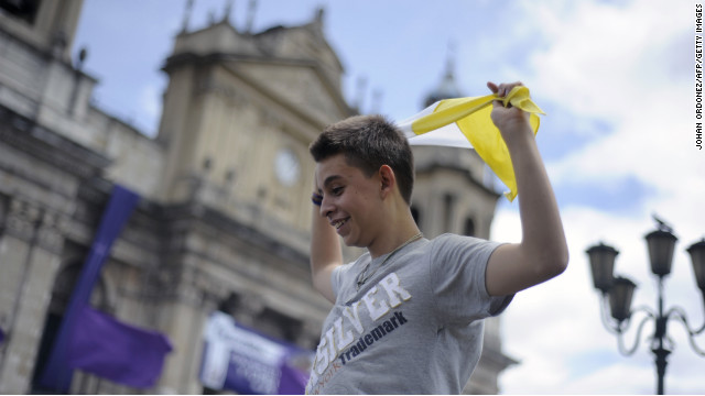 A young man waves a flag of the Vatican after the announcement of the election of Argentina's cardinal Jorge Bergoglio, as Pope Francis in Guatemala City.