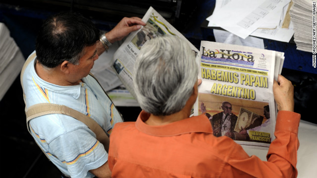 Employees of the evening newspaper La Hora in Guatemala City, Guatemala, review printed editions with the announcement of the election of Pope Francis.