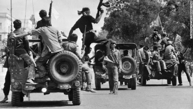 Khmer Rouge guerilla soldiers wearing black uniforms drive into Phnom Penh in April 1975, as Cambodia falls under the control of the Khmer Rouge.