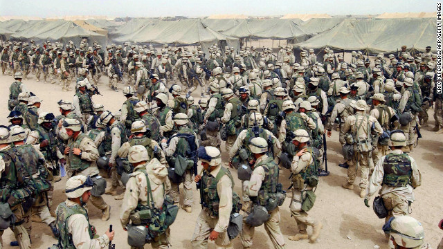 U.S. Marines in northern Kuwait gear up after receiving orders to cross the Iraqi border on March 20, 2003. It has been 10 years since the American-led invasion of Iraq that toppled the regime of Saddam Hussein. Look back at moments from the war and the legacy it left behind. For more, view <a href='http://www.cnn.com/SPECIALS/world/iraq/index.html' target='_blank'>CNN's complete coverage of the Iraq War anniversary.</a>