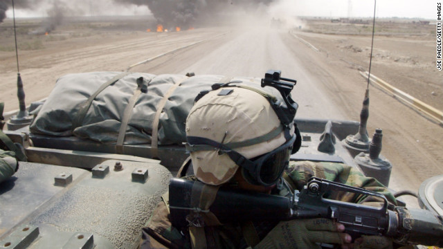 A U.S. Marine from Task Force Tarawa engages Iraqi forces from an armored assault vehicle on March 23, 2003, in the southern city of Nasiriyah.