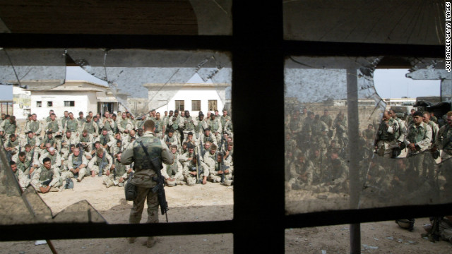 Marines hold a memorial service for friends killed in a battle weeks earlier on April 13, 2003, near Al-Kut, Iraq.