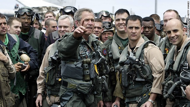 Dressed in a flight suit, President Bush meets pilots and crew members of the aircraft carrier USS Abraham Lincoln who were returning to the United States on May 1, 2003, after being deployed in the Gulf region.