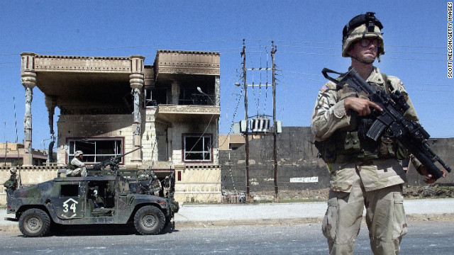 U.S. Army 101st Airborne troops investigate a house where Saddam Hussein's sons Uday and Qusay were killed in Mosul, Iraq, on July 23, 2003. The house, in an affluent neighborhood, was the scene of a fierce gunbattle.