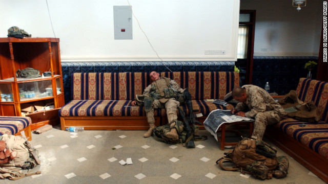 Marines rest and check a map in a house during an offensive in Fallujah on November 11, 2004.