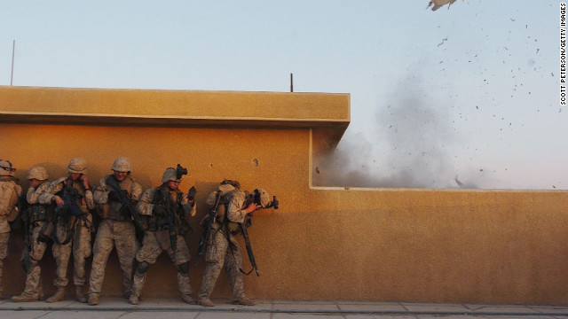 Marines use explosives to open rooftop doors while searching houses in Fallujah for insurgents on November 22, 2004.