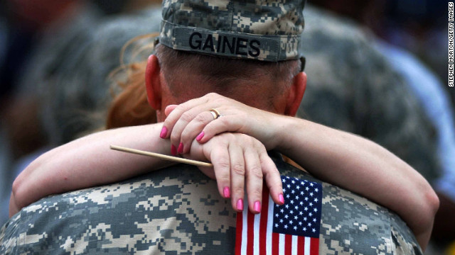 Sgt. Thomas Gaines kisses his wife during a welcome-home ceremony in Fort Stewart, Georgia, on May 11, 2006. About 280 members of the Georgia National Guard 48th Brigade returned home from a year-long deployment to Iraq.