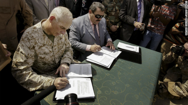 Maj. Gen. John Kelly, left, and Anbar province Gov. Maamoun Sami Rashid al-Alwani sign papers during a handover ceremony in Ramadi on September 1, 2008. The U.S. military turned over security control of Iraq's biggest province, once a stronghold of the Sunni insurgency.