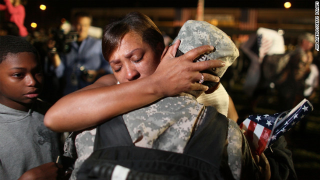 Army Sgt. Donald Lewis from the 1st Cavalry Division is greeted by his wife, Nicole Lewis, after his brigade arrived home in Fort Hood, Texas, on November 10, 2009, after a year of deployment in Iraq.