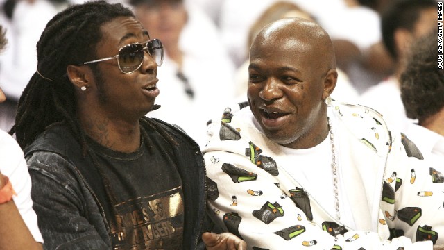 Lil Wayne and Baby AKA Birdman watch the New Jersey Nets play the Miami Heat during the NBA playoffs in 2006.