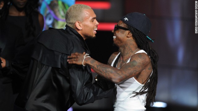 Singer Chris Brown, left, and Lil Wayne embrace onstage during the 2011 BET Awards.