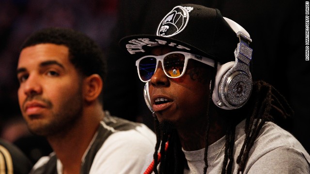Lil Wayne and hip-hop artist Drake, left, sit courtside during the 2012 NBA All-Star Game.