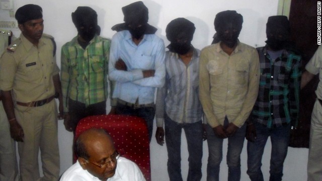 The five hooded gang-rape suspects are paradedn in front of reporters in Datia on Sunday.