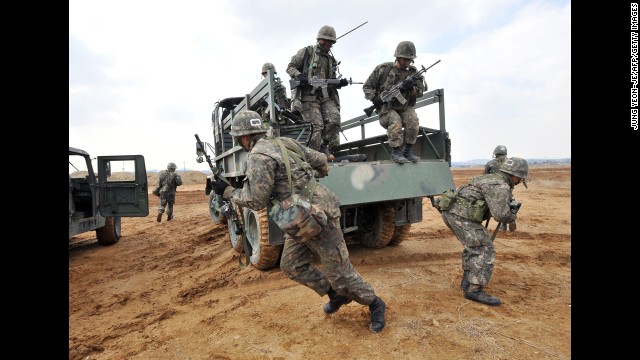 South Korean army soldiers jump off a military truck during a drill outside a U.S. airbase in Pyeongtaek as part of annual joint exercises with the United States on March 14.