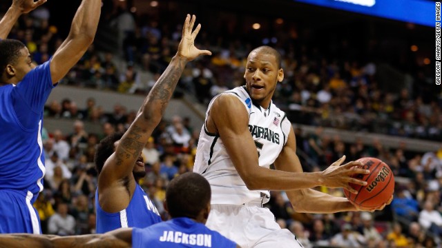 Adreian Payne of the Michigan State Spartans, right, looks to pass as he drives against the Memphis Tigers on March 23 in Auburn Hills, Michigan. The Spartans won 70-48.