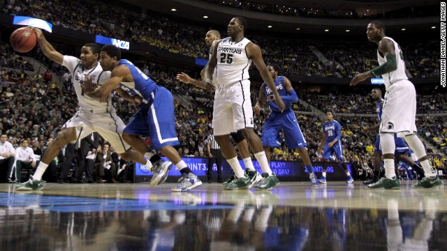 Gary Harris of Michigan State, left, battles Geron Johnson of Memphis for the ball on March 23.