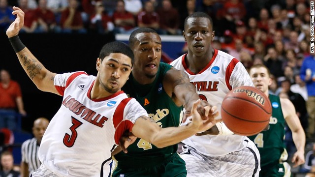 Peyton Siva of Louisville Cardinals, left, steals the ball from Greg Smith of Colorado State on March 23.