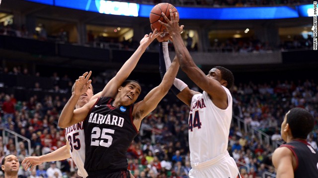 Kaleb Tarczewski, left, and Solomon Hill, right, of the Arizona Wildcats go after a loose ball against Kenyatta Smith of the Harvard Crimson on March 23 in Salt Lake City. The Wildcats won 74-51.