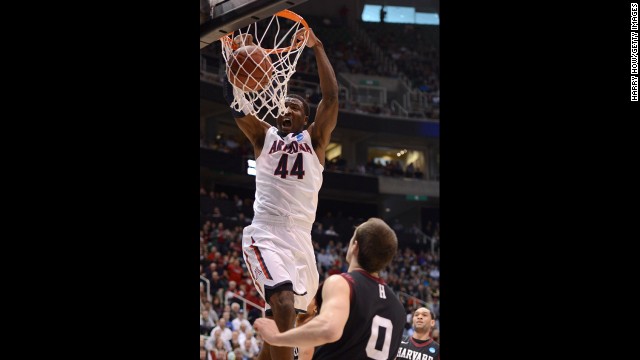 Arizona's Solomon dunks over Harvard's Laurent Rivard on March 23.