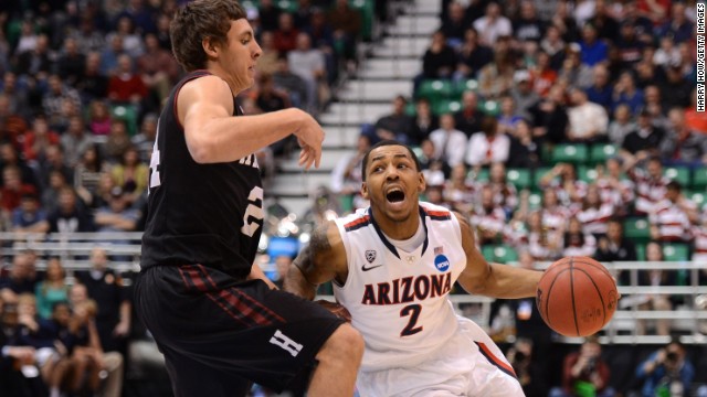 Mark Lyons of Arizona drives on Harvard's Jonah Travis March 23.