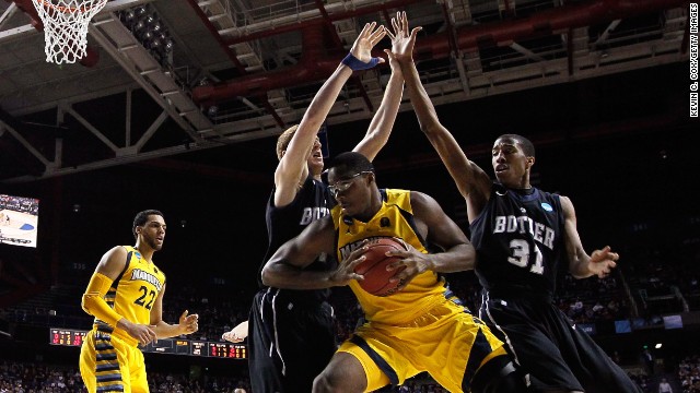 Chris Otule of the Marquette Golden Eagles, second from right, handles the ball against Erik Fromm, second from left, and Kameron Woods, right, of the Butler Bulldogs on March 23 in Lexington, Kentucky.