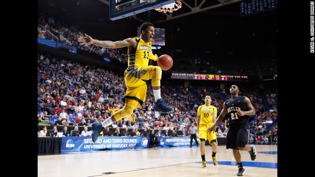 Vander Blue of Marquette, center, reacts after stealing the ball and making a dunk against Butler on March 23.