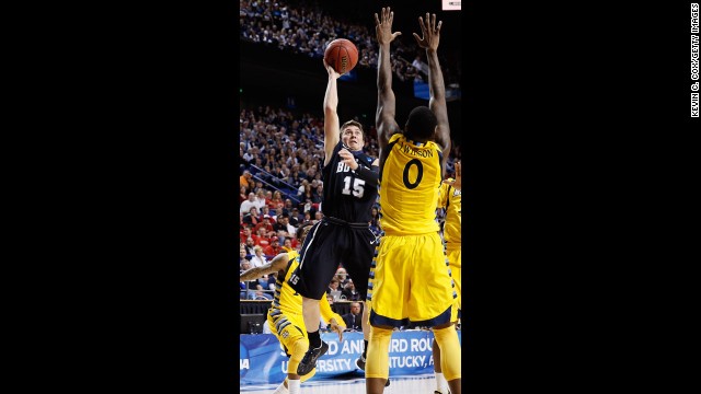 Rotnei Clarke of Butler, left, shoots over Jamil Wilson, right, of Marquette on March 23.