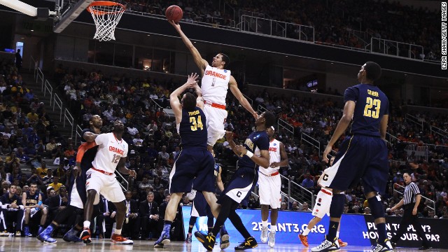 Michael Carter-Williams of the Syracuse Orange, center, goes up over Robert Thurman, left of center, of the California Golden Bears on March 23 in San Jose. Syracuse won 66-60.