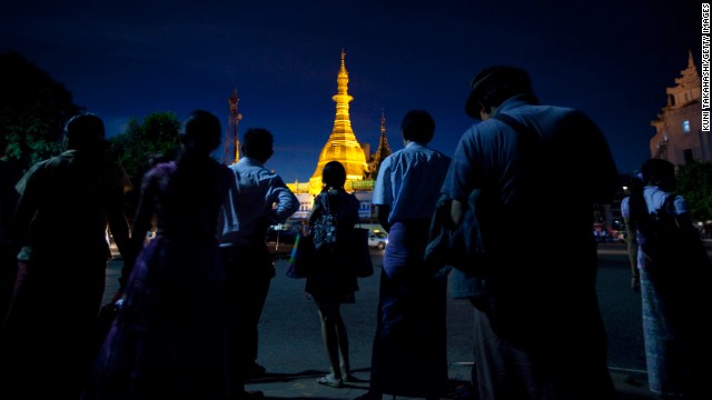 The Sule Pagoda lights up the night sky as people wait for the bus in Yangon. Pagodas serve as shrines for Theravada Buddhists, the majority religion in the country.