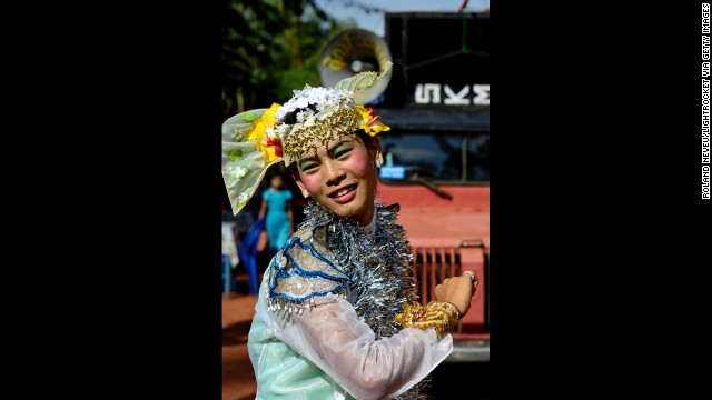 A young Burmese man dressed as a woman entertains residents of a neighborhood in Mawlamyine.