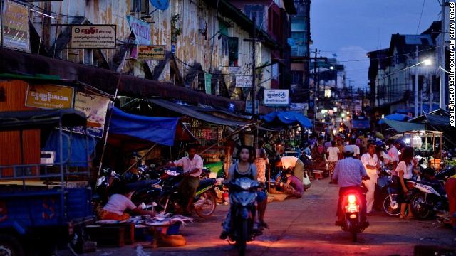 People pass through a shopping area near the central market in Mawlamyine.