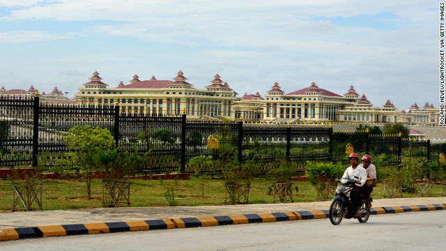 A motorbike passes the Assembly of the Union, where the country's upper and lower houses of representatives meet, in Naypyidaw. It is locally called Pyidaungsu Hluttaw.