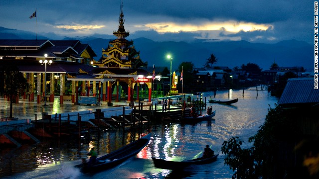 The temple of Phaung Daw U, the largest on Inle Lake, is lit as dusk falls in the village of Ywama.