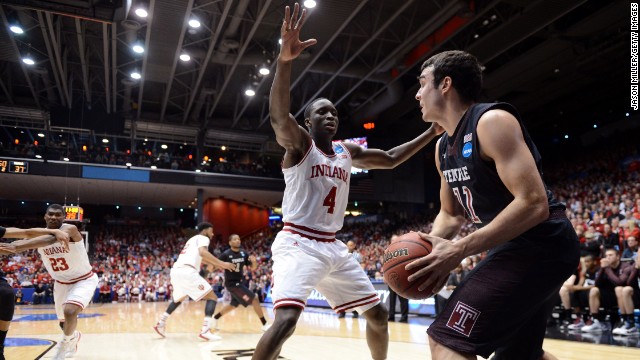 Victor Oladipo of the Indiana Hoosiers, center, defends the inbound pass of T.J. DiLeo of the Temple Owls on March 24 in Dayton, Ohio. Indiana won 58-52.