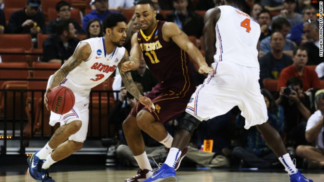 Mike Rosario of Florida, left, drives against Joe Coleman of Minnesota on March 24 in Austin, Texas. Florida defeated Minnesota 78-64.