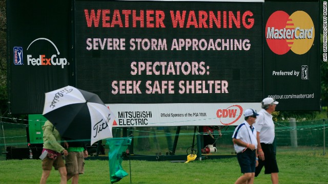 Fans seek shelter during the final round of the Arnold Palmer Invitational at the Bay Hill Club and Lodge in Orlando, Florida.