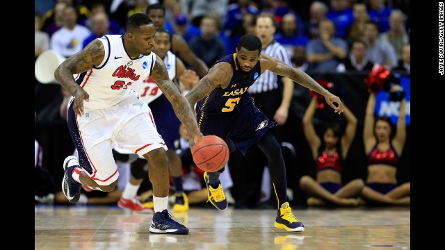 Murphy Holloway of Ole Miss and Ramon Galloway of La Salle chase down the ball on March 24.