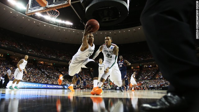 Kenny Kadji of the Miami Hurricanes tries to save a loose ball while teammate Julian Gamble looks on in the first half against the Illinois Fighting Illini on March 24 in Austin, Texas. Miami won 63-59.