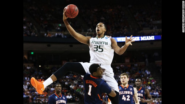 Kenny Kadji of Miami leaps over D.J. Richardson of Illinois on March 24.