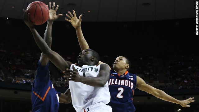 Durand Scott of Miami shoots against Joseph Bertrand of Illinois on March 24.