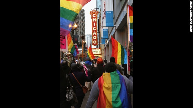 Demonstrators carry flags through the streets of Chicago on Monday. 