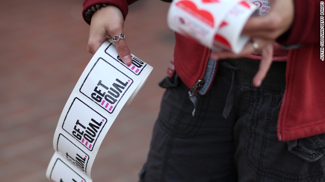 A supporter of same-sex marriage passes out stickers in San Francisco.