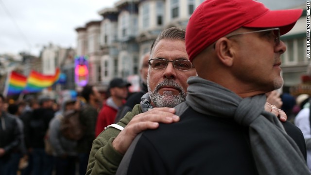 Ken Mauldin, left, hugs Larry Davanzo during the demonstration in San Francisco.