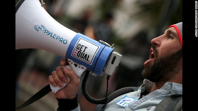 Trey Allen yells into a bullhorn during the rally in San Francisco.