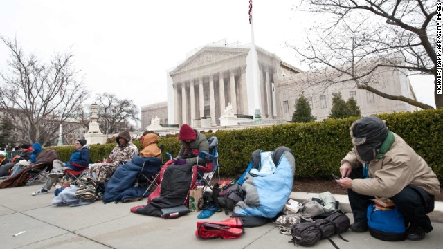 People rest in front of the Supreme Court in Washington on Sunday in the line for the hearing.