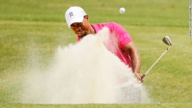 Woods hits out of the bunker on the ninth hole during the first round of the PGA Championship in August 2011. <a href='http://edition.cnn.com/2011/SPORT/golf/08/12/golf.pga.woods.cut/index.html'>He failed to make the cut at the PGA championship</a> for the first time in his career. 