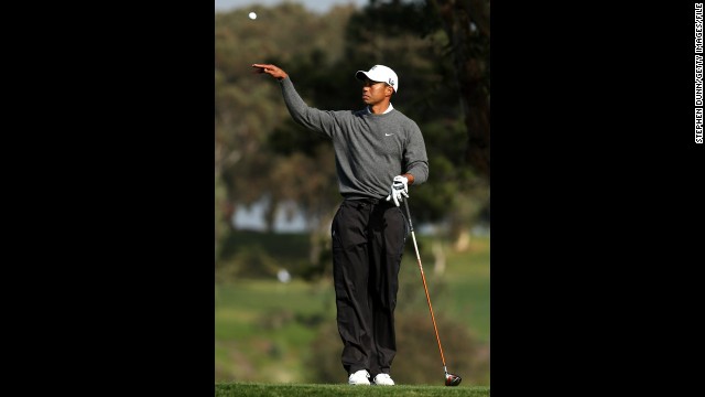 Woods tosses his ball to his caddie at the Farmers Insurance Open at Torrey Pines in January 2013. He started the new year in fine form by winning his 75th PGA Tour title in the Farmers Insurance Open. 