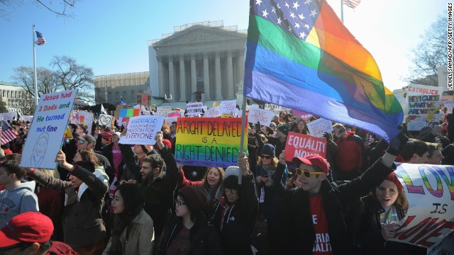 Same-sex marriage supporters shout slogans in front of the U.S. Supreme Court on Tuesday.