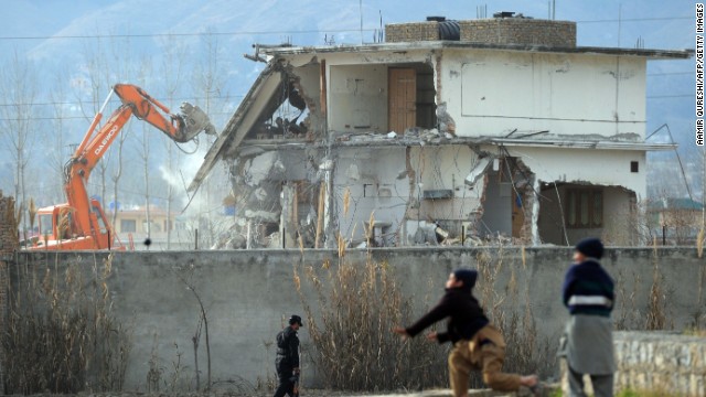 A demolition crew works to dismantle the compound on February 26, 2012.